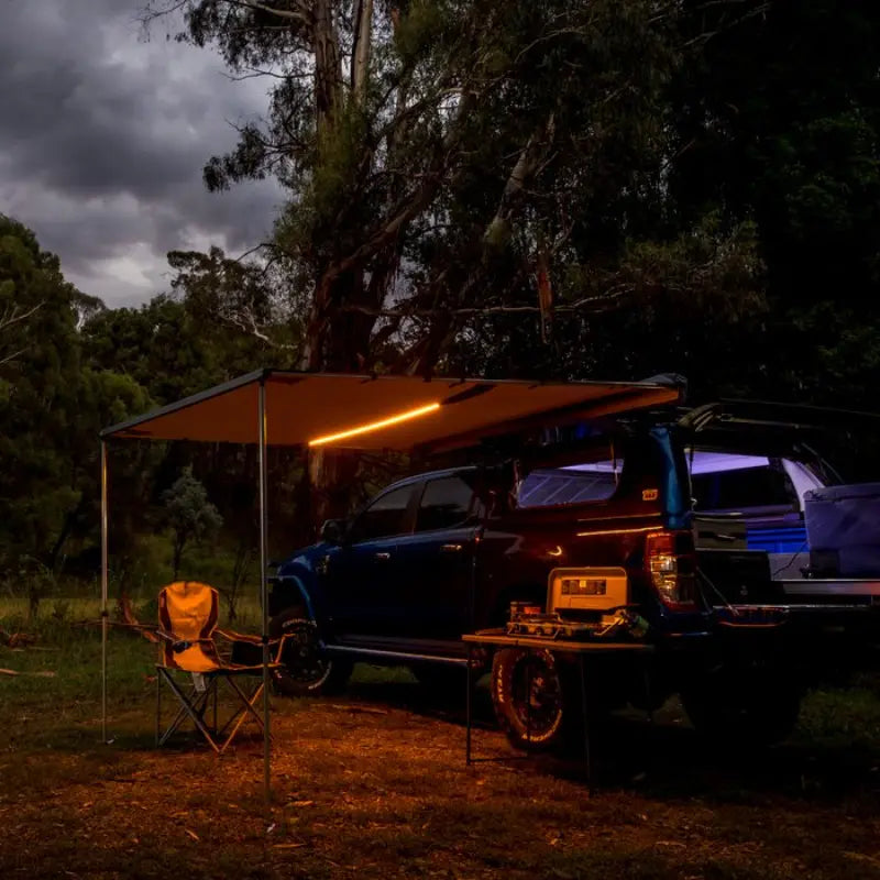 ARB Awning With Led Light Kit Opened Amber LED Mode at night with Chair sitting underneath