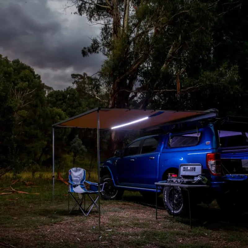 ARB Awning With Led Light Kit Opened White LED Mode at night with Chair sitting underneath