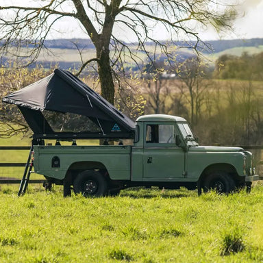 Tent and Trail Adventure Series Rooftop tent wider side view set up on back of trailer truck