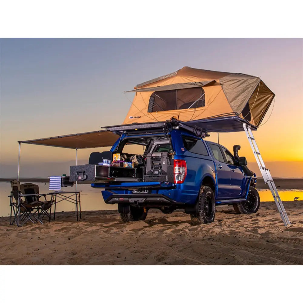 The ARB Flinders Rooftop tent and the awning set up on vehicle on the beach