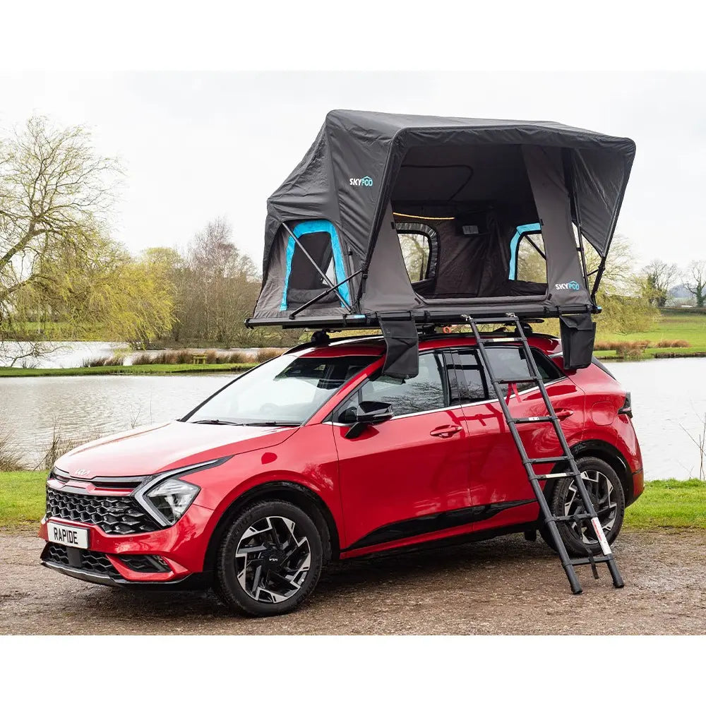 View of the SkyPod Rapide RTT on top of red car with ladders extended