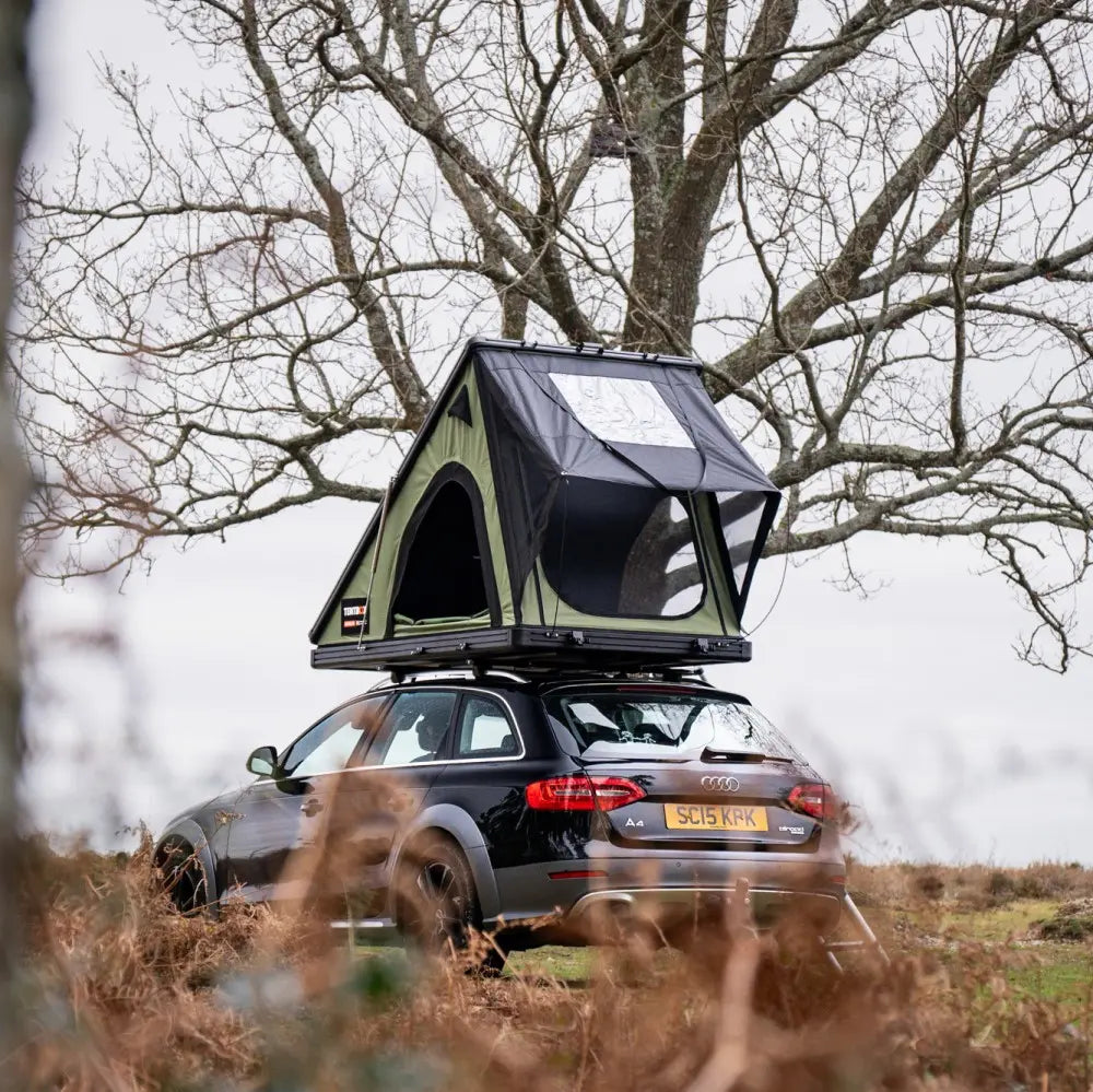 forest green cargo 2.0 on car in field rear view