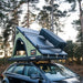 tentbox cargo 2.0 open on top of car with the storage box attached to the roofbars